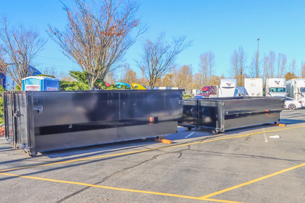 Professional dumpster rental service with roll-off container on residential driveway in West Hanover